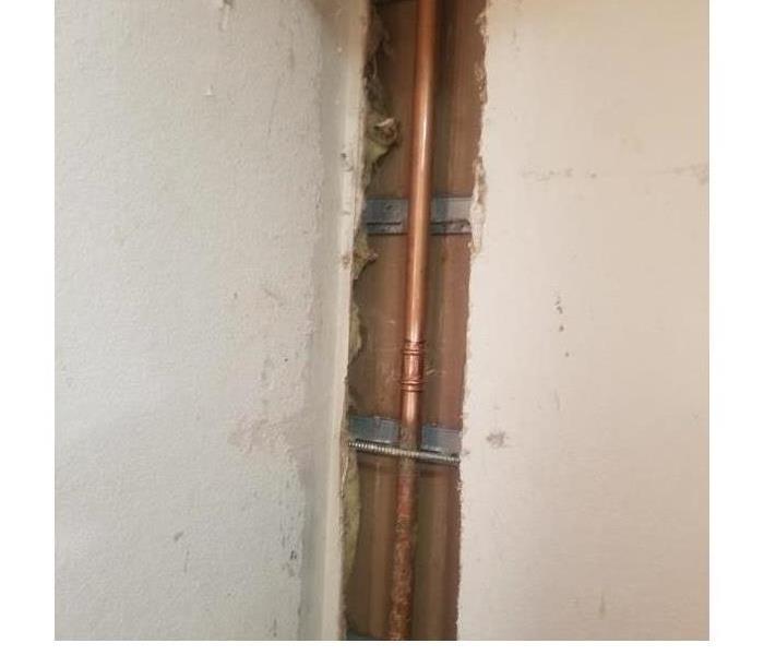 A home with water damage in its wall by a pipe break